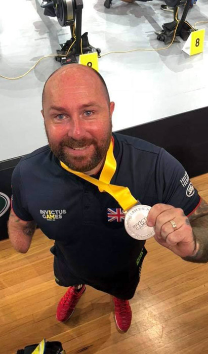 Dave proudly shows off his silver medals
